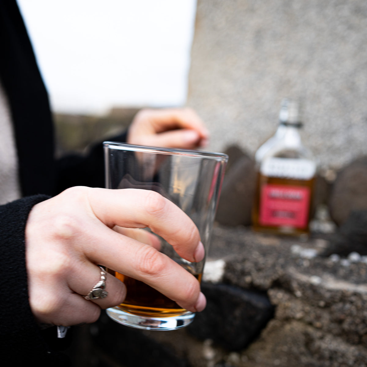 Opening a whiskey naggin by Redacted